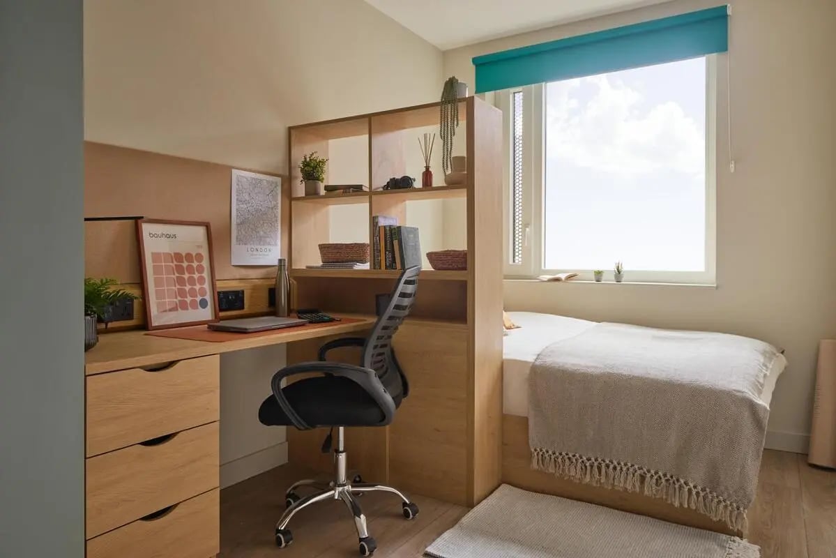 Desk chair bed and shelving student room at Ark Canning Town in London Student Accommodation