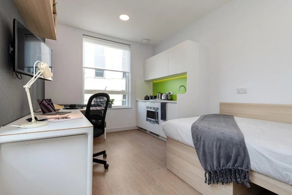 Desk laptop chair bed small kitchen studio apartment at Collegiate Middle Street in Portsmouth Student Accommodation