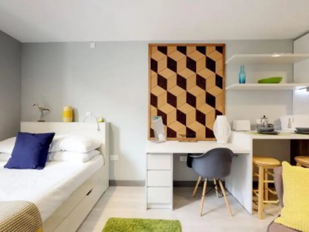 Bed desk shelves and kitchen area living room at The Walls in Southampton Student Accommodation