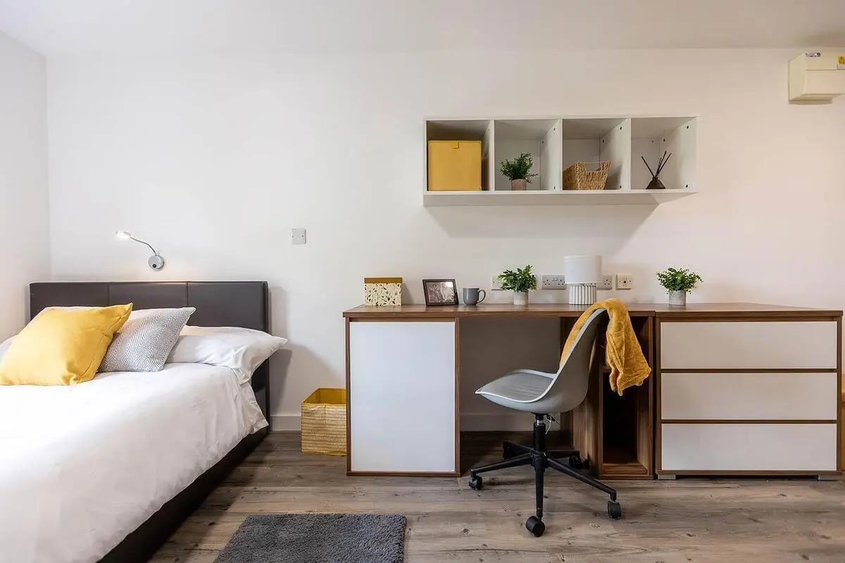 Bed desk chair shelves and storage bedroom study area at Austin Hall in Leeds Student Accommodation