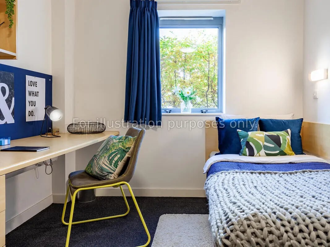 Desk chair bed with pillows and plants bedroom at Polhill Park in Bedford Student Accommodation