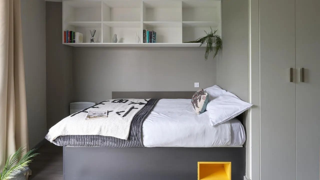 Bed bookshelf pillows wardrobe bedroom at Gosford Gate in Coventry Student Accommodation