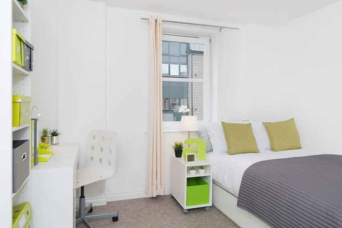 White desk chair bookshelf bed pillows bedroom at Froghall in Aberdeen Student Accommodation