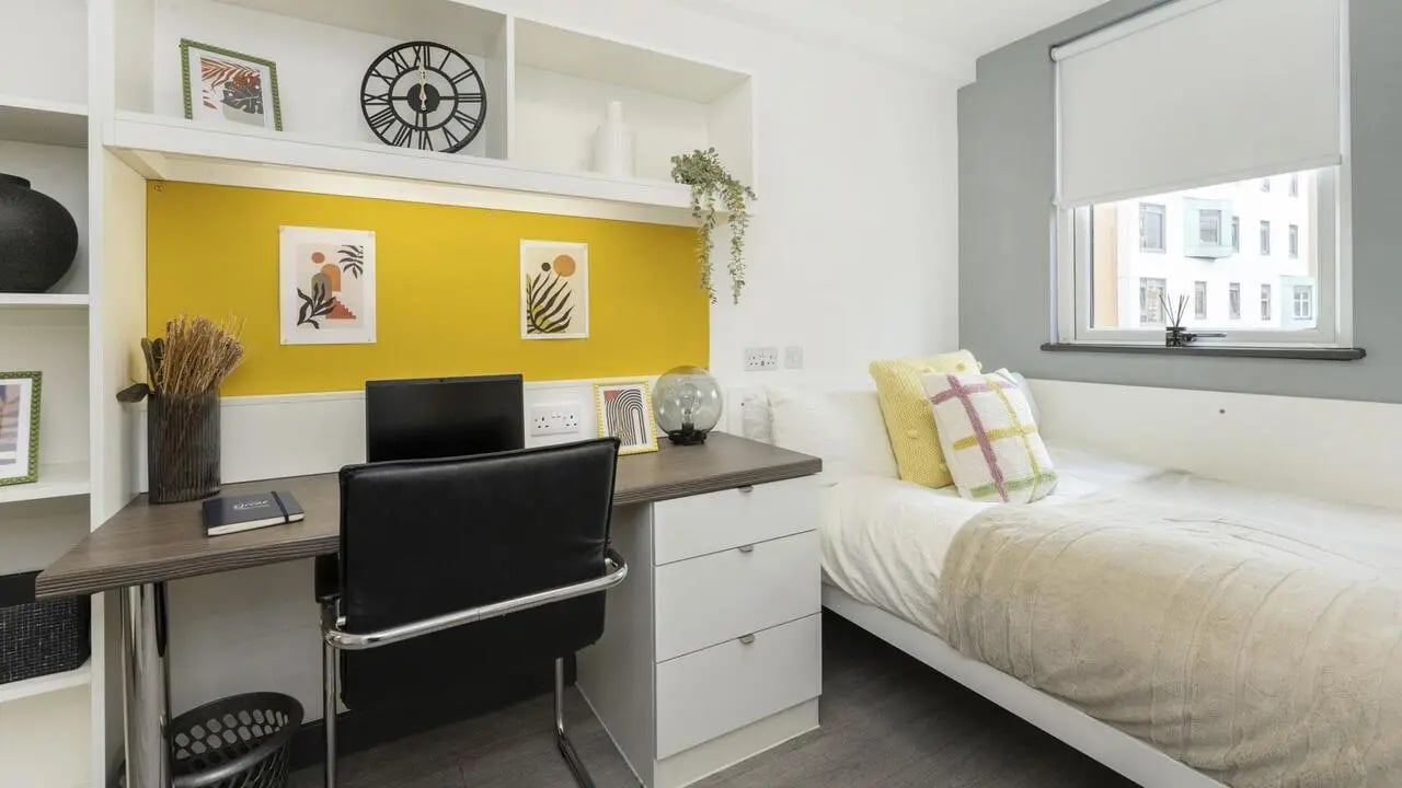 Desk with laptop bed and artwork bedroom at Albert Place in Newcastle Upon Tyne Student Accommodation