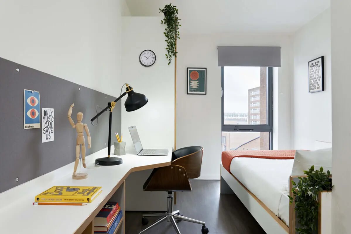 Desk chair lamp laptop books wooden mannequin bed bedroom at Sharman Court in Sheffield Student Accommodation