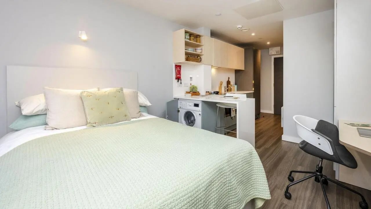 Bed washing machine counter desk chair bedroom at The Aspen in Leicester Student Accommodation