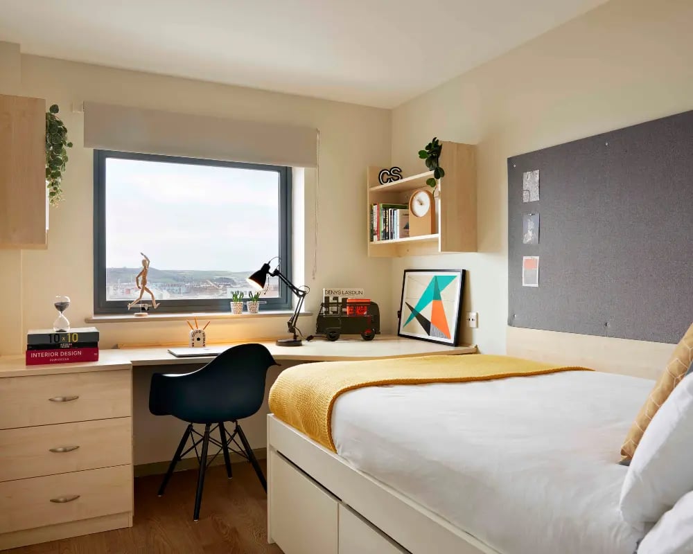 Desk bed shelving and cork board bedroom at Discovery Heights in Plymouth Student Accommodation