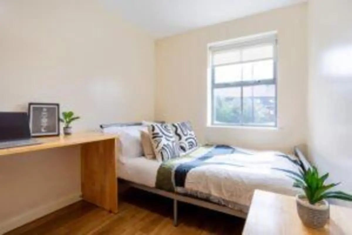 Bed desk laptop plant framed art bedroom at dwell Hotwells House in Bristol Student Accommodation