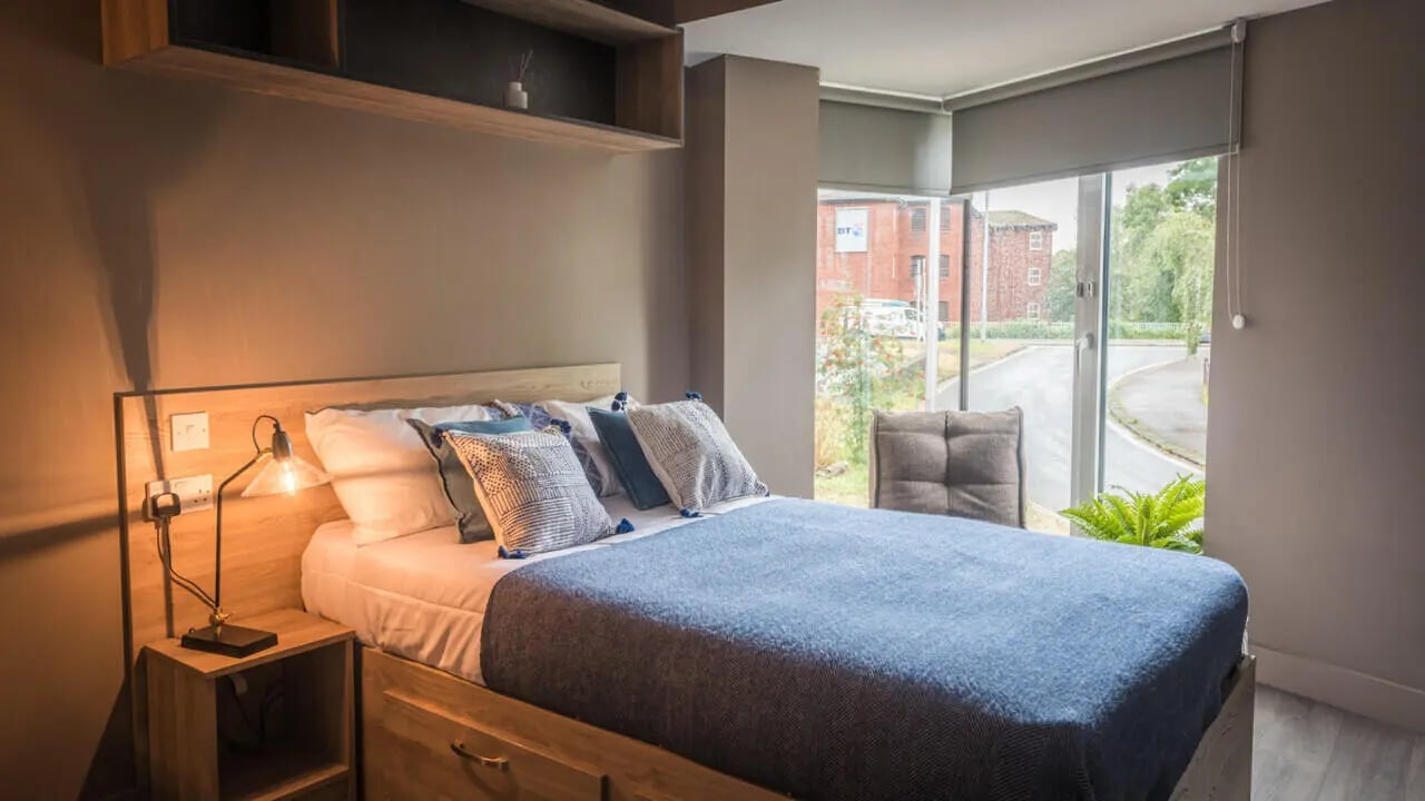Bed with pillows and bedside lamp bedroom at West Gate in Exeter Student Accommodation
