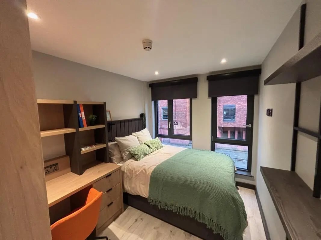 Bed desk shelves orange chair bedroom at The Port On The Square in Bristol Student Accommodation