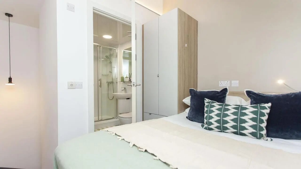 Bed with pillows wardrobe and ensuite bathroom Bedroom at Gillows in Lancaster Student Accommodation