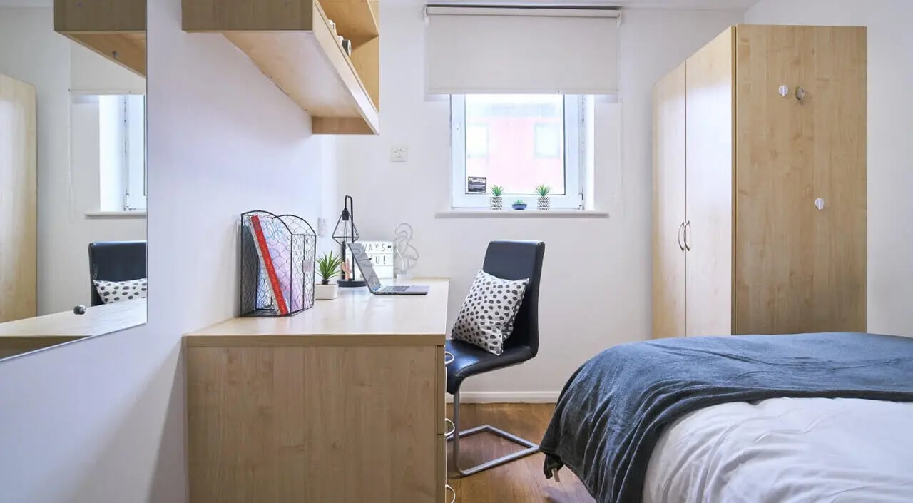 Desk laptop chair shelves wardrobe bed bedroom at Manchester House in Manchester Student Accommodation
