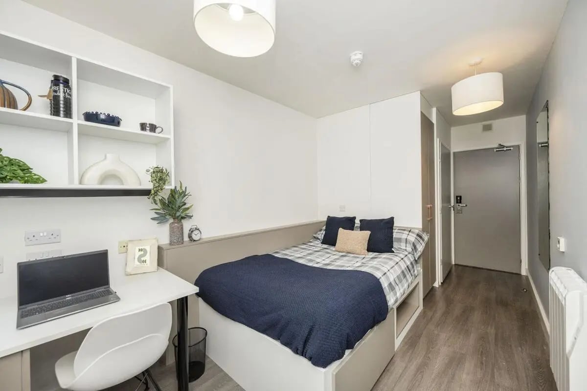 Bed desk shelves and door Bedroom at McDonald Road in Edinburgh Student Accommodation