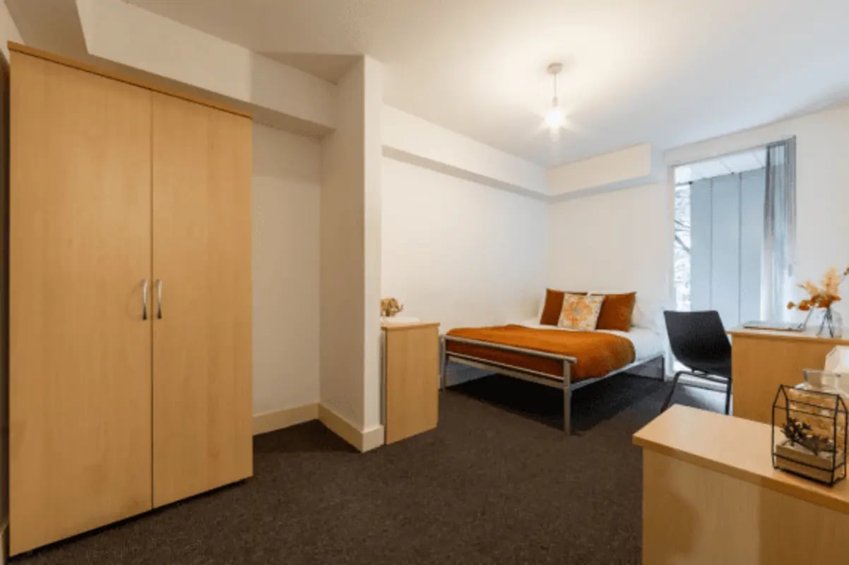 Closet bed desk and chair bedroom at The Grafton in Manchester Student Accommodation