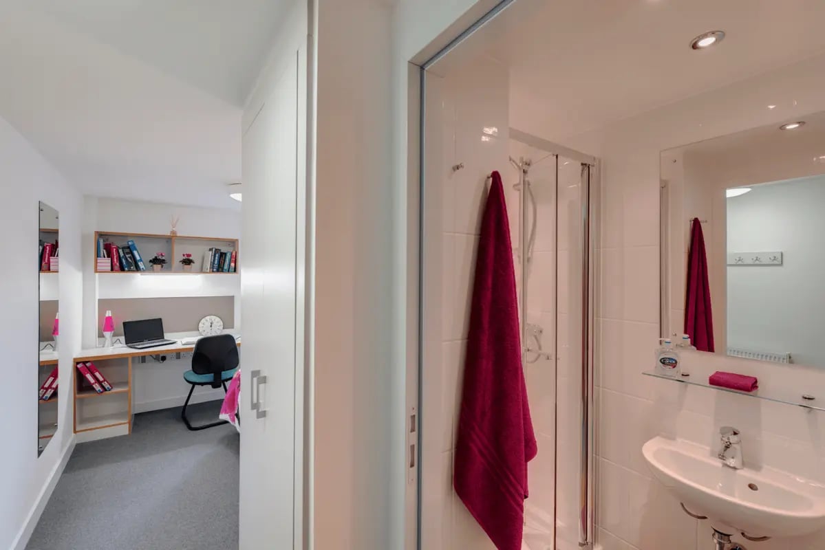Desk with laptop and chair adjoining bathroom Image Type at The Old Dairy in Plymouth Student Accommodation