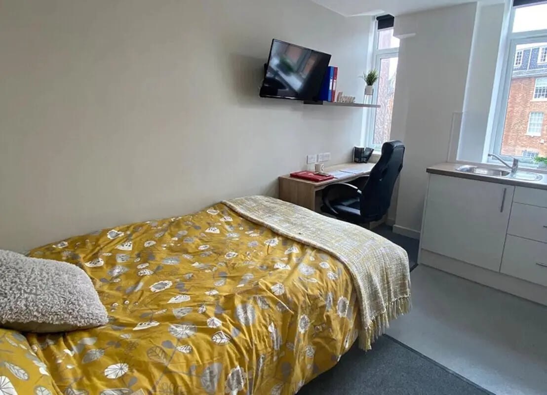 Bed desk chair TV sink kitchen student bedroom at Renaissance House in Leicester Student Accommodation