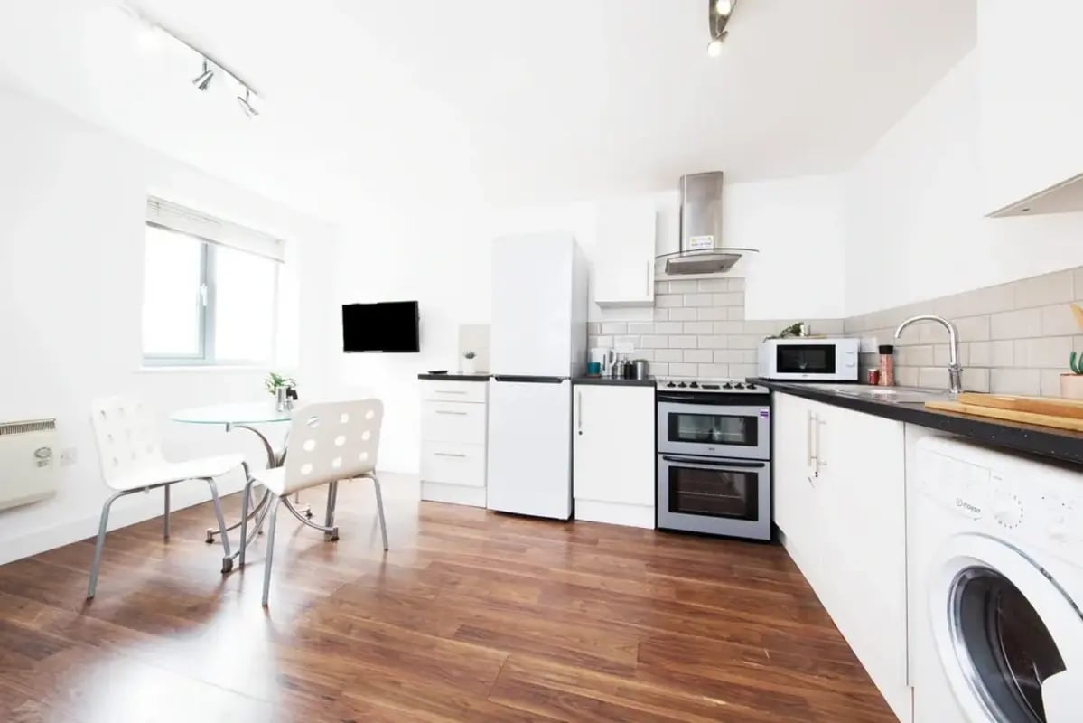 Table TV microwave oven fridge washer kitchen at Grange Lane Apartments in Leicester Student Accommodation