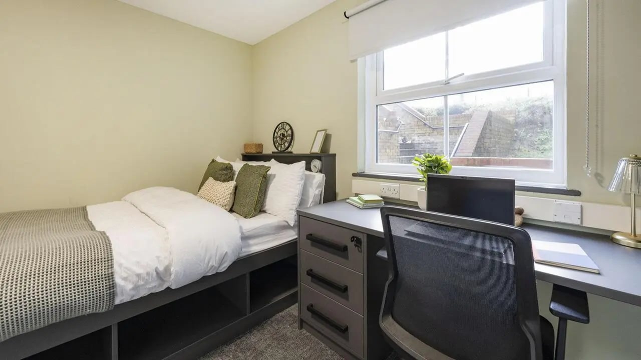 Bed desk chair and window Bedroom at Dean House in London Student Accommodation