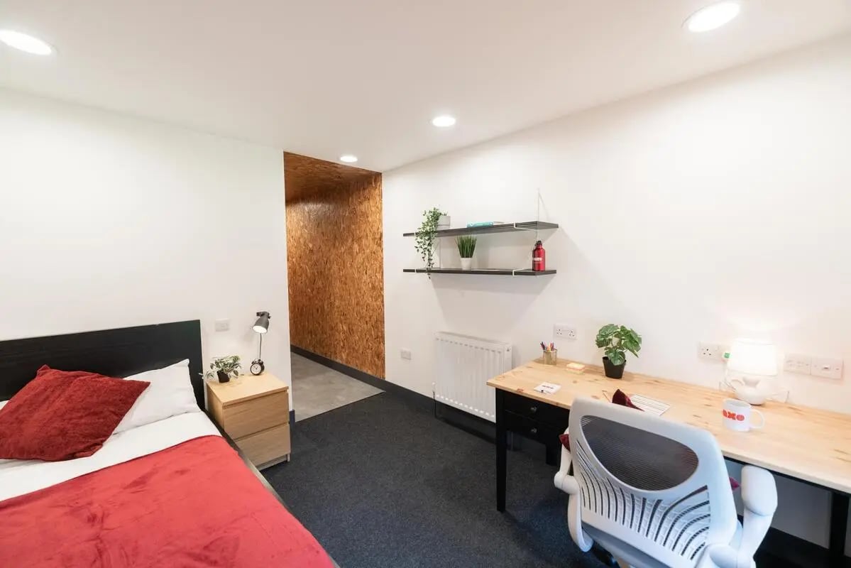 Bed desk chair shelves lamp student accommodation bedroom at AXO Camden in London Student Accommodation