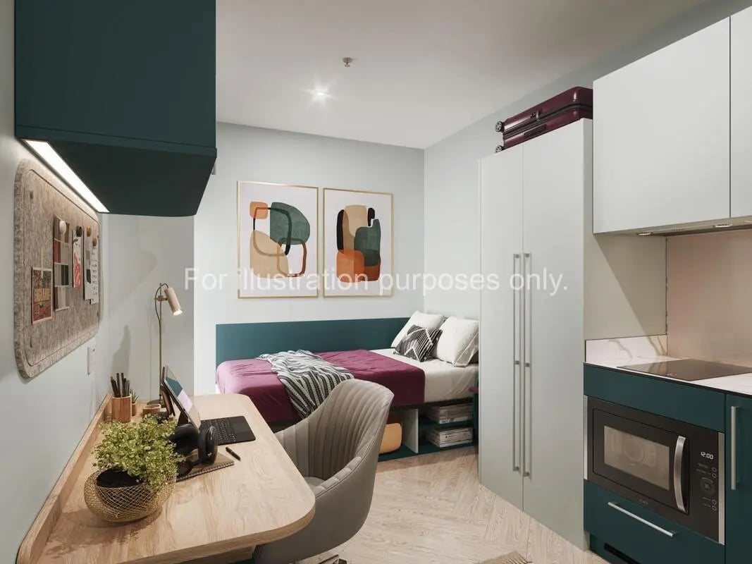 Desk bed wardrobe and kitchen area bedroom at Willen House in London Student Accommodation
