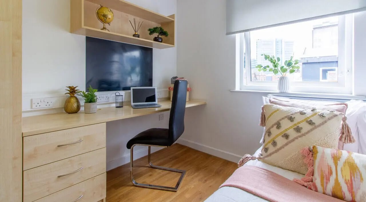 Desk with laptop chair and bed bedroom at Canalside in Birmingham Student Accommodation