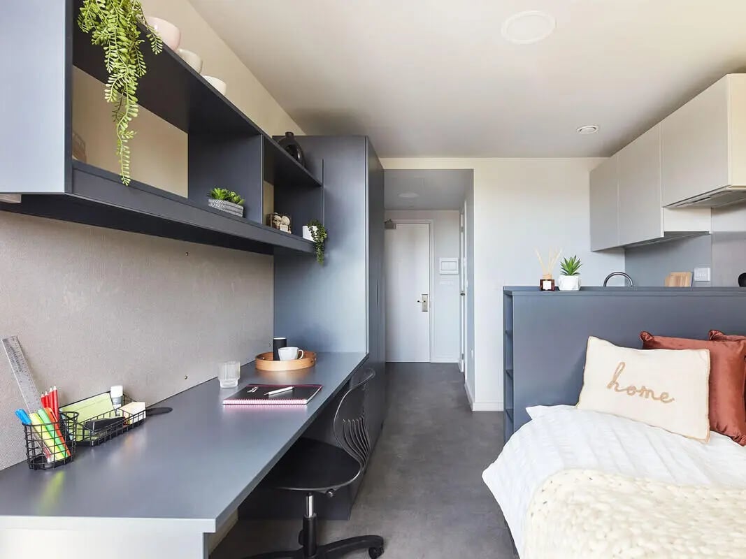 Desk bed and shelving unit bedroom at Ravilious House in Brighton Student Accommodation