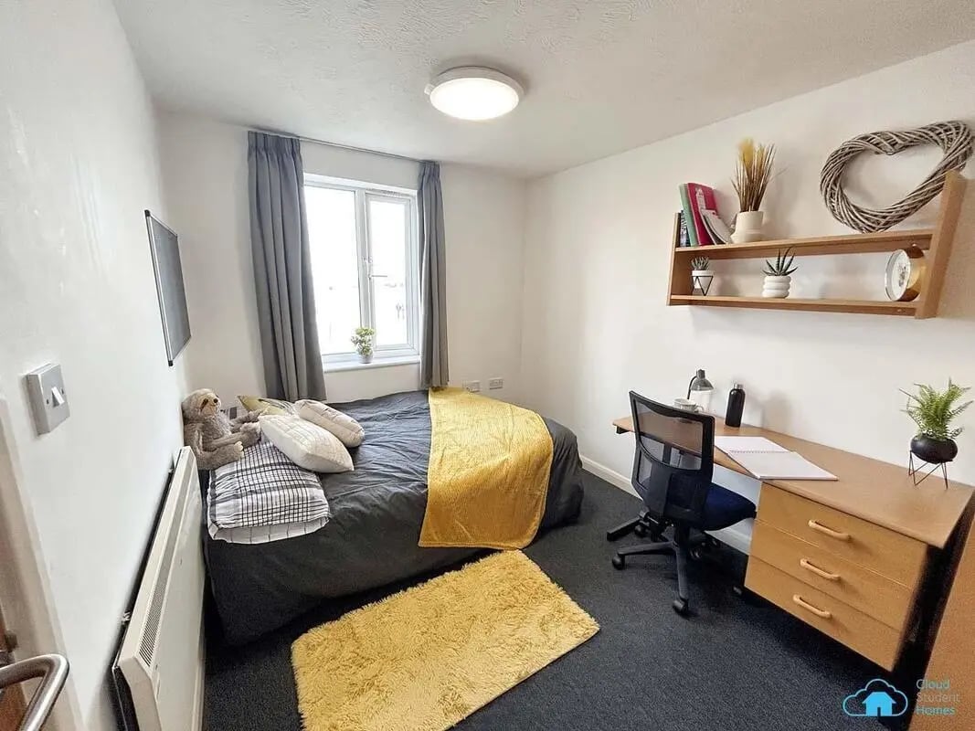 Bed desk and shelf student bedroom at Rochester Student Village in Rochester Student Accommodation