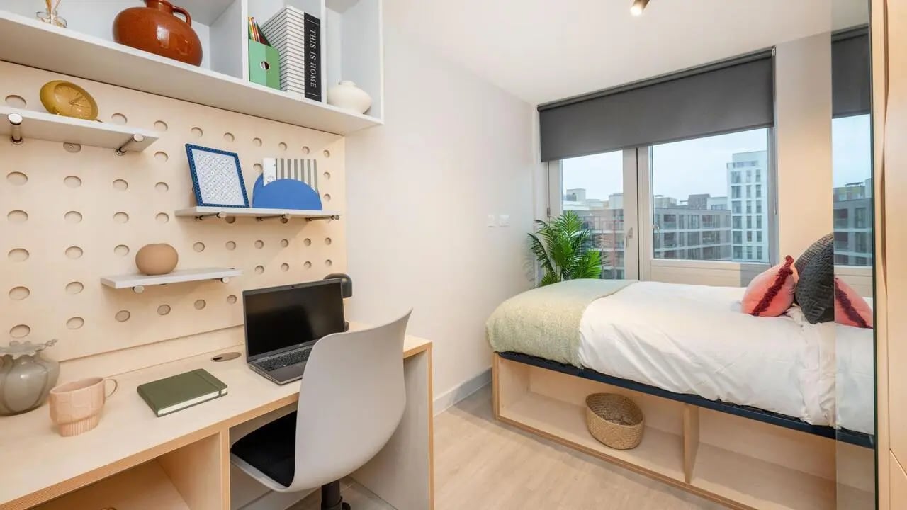 Desk laptop chair bed with pillows bedroom interior at Wick Park in London Student Accommodation