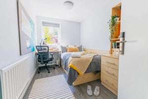 Bed desk chair rug and radiator Bedroom at Beech Gardens in Birmingham Student Accommodation