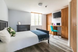 Bed dresser desk chair television bedroom at Standard Hill in Nottingham Student Accommodation