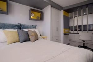 Bed with pillows wardrobe desk and chair bedroom at The Bank Leicester in Leicester Student Accommodation