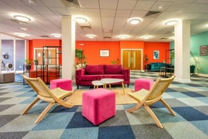 Modern lounge with pink sofas and chairs living room at Newton House Glasgow in Glasgow Student Accommodation