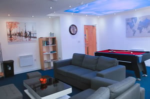 Sofas pool table and art in living room at Renaissance House in Leicester Student Accommodation