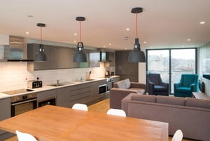 Modern kitchen with sofas and chairs living area at CityBlock Marton Street in Lancaster Student Accommodation