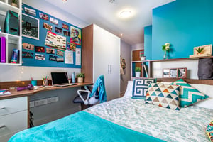 Bed desk wardrobe and wall art bedroom at Kaplan Living Glasgow - Old Dumbarton Road in Glasgow Student Accommodation