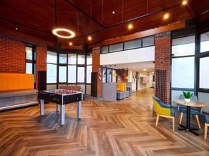 Foosball table orange seating modern lounge area at Hockley Point in Nottingham Student Accommodation