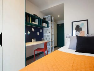 Desk shelves red chair and bed Bedroom at Highlight Parkgate in Dublin Student Accommodation