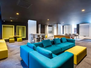Blue sectional sofa pool table study booths living room at Lee Point in Cork Student Accommodation