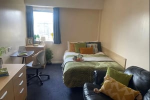 Bed desk chair pillows and tray bedroom at Dinwiddy House in London Student Accommodation