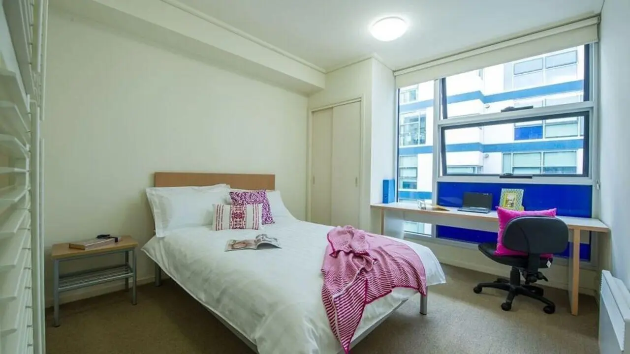 Bed desk chair and window bedroom at Student Living - 800 Swanston in Melbourne Student Accommodation