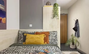 Bed with patterned duvet and pillows bedroom at Concept Place in Leeds Student Accommodation