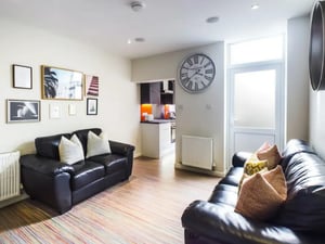 Two black sofas with pillows on floor living room at 17 Carlton Road in Stoke-On-Trent Student Accommodation