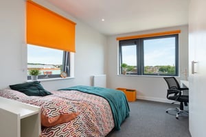 Bed desk orange baskets bedroom at Central Living in Exeter Student Accommodation
