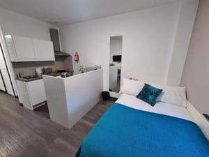 Bed kitchen white cabinets and oven living room at St James House in Newcastle Upon Tyne Student Accommodation