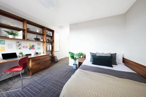 Desk shelves laptop chair and bed bedroom at Collegiate Bagot Street in Birmingham Student Accommodation