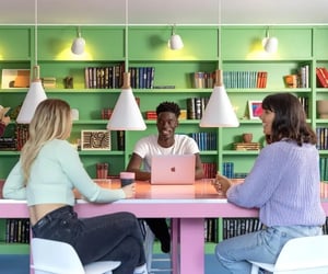 Three students at a table with laptop study area at Scape Guildford in Guildford Student Accommodation