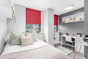 Bed pillows desk chairs shelving unit bedroom at Northgate House in Derby Student Accommodation