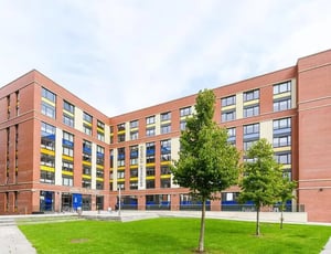 Modern brick student accommodation building with trees exterior at Merchant Studios in Glasgow Student Accommodation