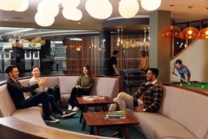 Students relaxing and playing pool living room at Drapery Place in London Student Accommodation