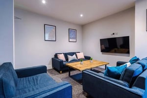 Two sofas coffee table and television Living room at 9 Manor Drive in Leeds Student Accommodation